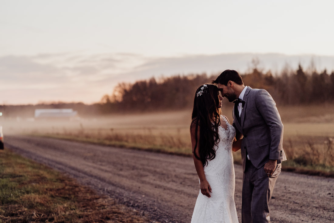 Couple on country road during sunset after wedding