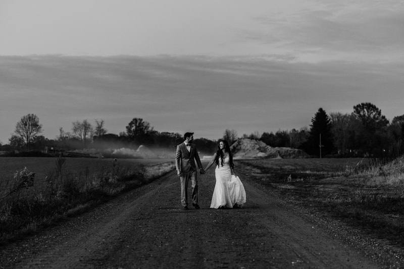 Black and white couple walking on country road