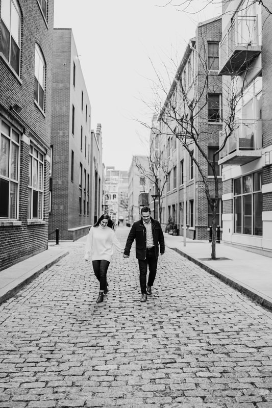 Black and white couple walking down brick road