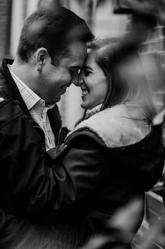 Black and white couple laughing about to kiss