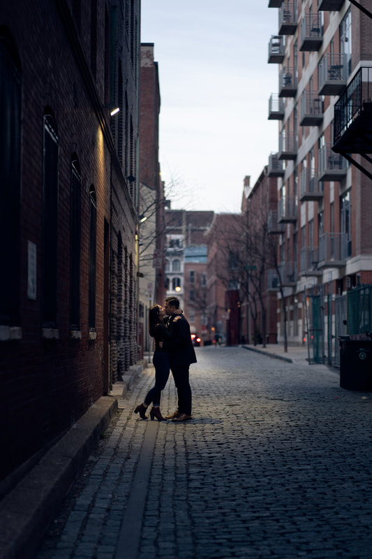 Sunset couple kissing in city streets