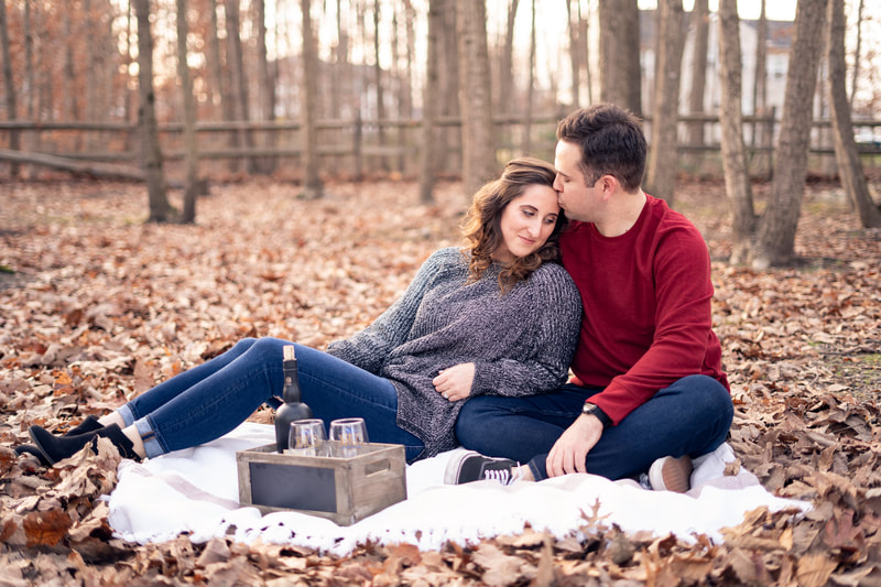 Couple having a wine picnic in the woods