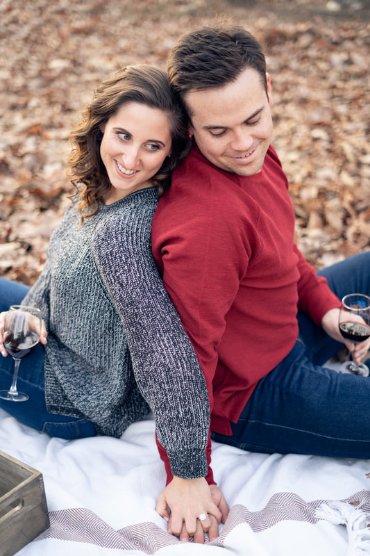 Couple having wine in fall on a blanket