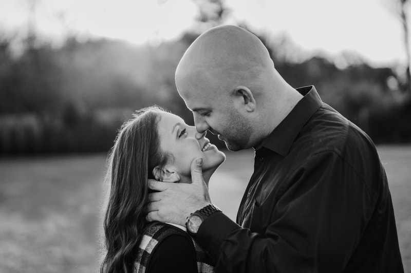 black and white engaged couple about to kiss