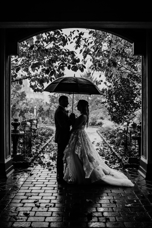 Couple under umbrella at Scotland Run Country Club in black and white